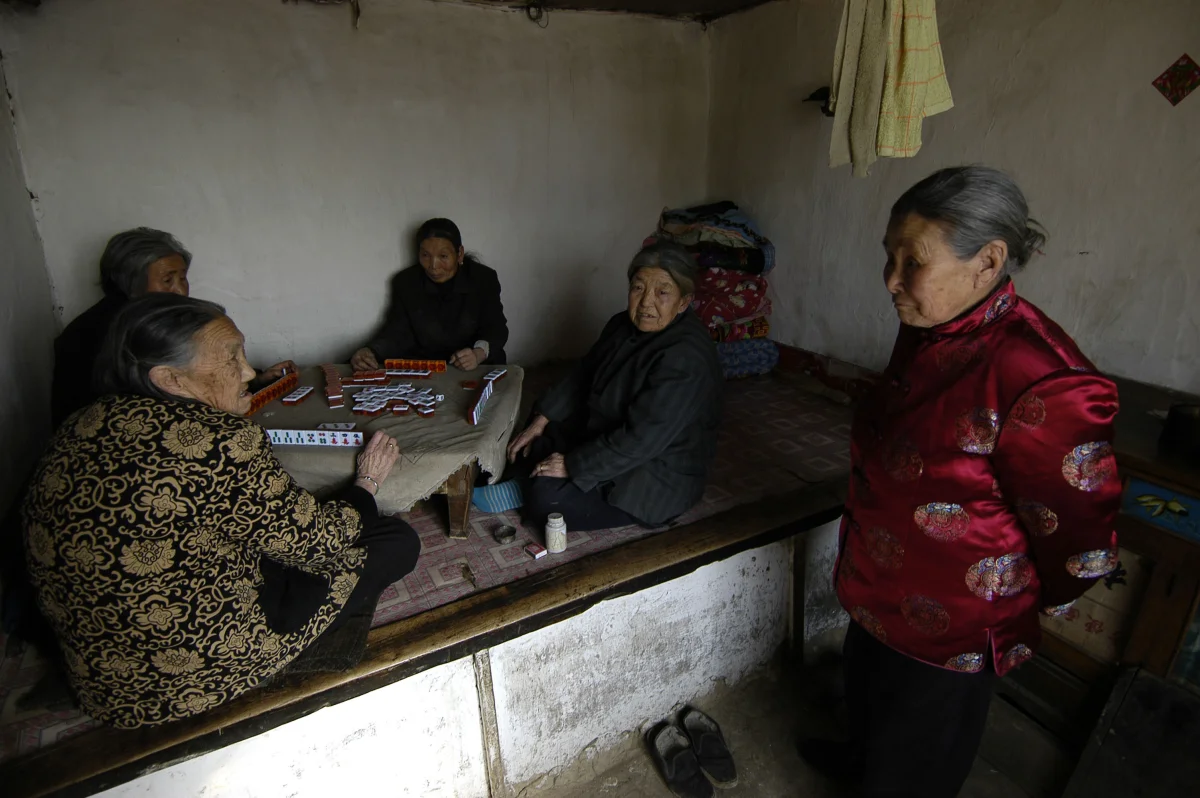 Meng Shujing (82) with grandson Shi Junguang (30) and great-grandson Shi Yaobin (5) at home in Sanjiazi near the town of Qiqihar in Heilongjiang province in North-east China. 2007