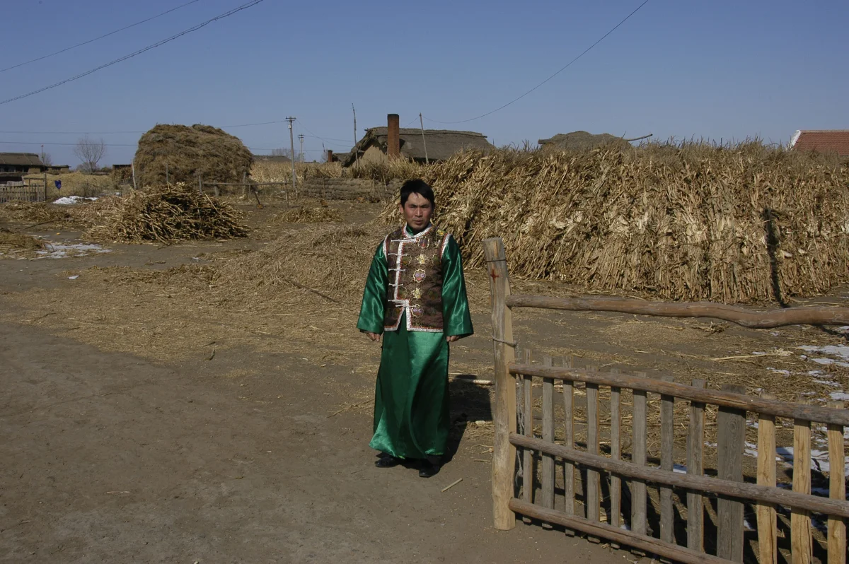 Shi Junguang (30) - the grandson of Meng Shujing (82) - and his son Shi Yaobin (5) at home in Sanjiazi near the town of Qiqihar in Heilongjiang province in North-east China, 2007.