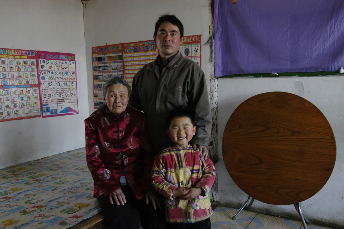 Meng Shujing (82) with grandson Shi Junguang (30) and great-grandson Shi Yaobin (5) at home in Sanjiazi near the town of Qiqihar in Heilongjiang province in North-east China. 2007