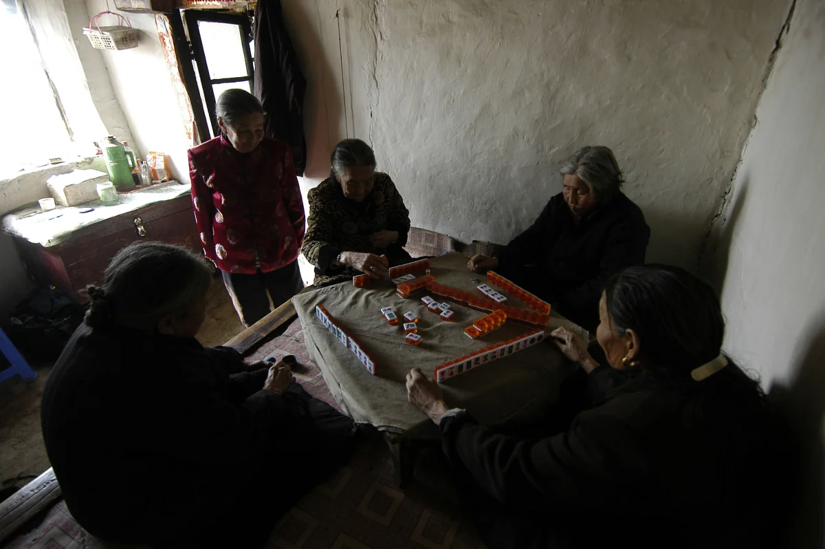 Meng Shujing (82)(L) with her two friends Yao Yun (82) (C) and Zhao Feng Lan (82) (R) also Manchu speakers in Sanjiazi near the town of Qiqihar in Heilongjiang province in North-east China. 2007