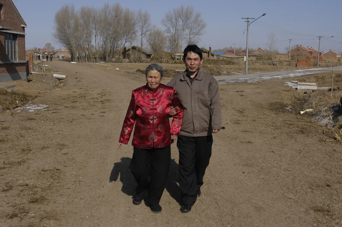 Meng Shujing (82) with grandson Shi Junguang (30) and great-grandson Shi Yaobin (5) at home in Sanjiazi near the town of Qiqihar in Heilongjiang province in North-east China. 2007