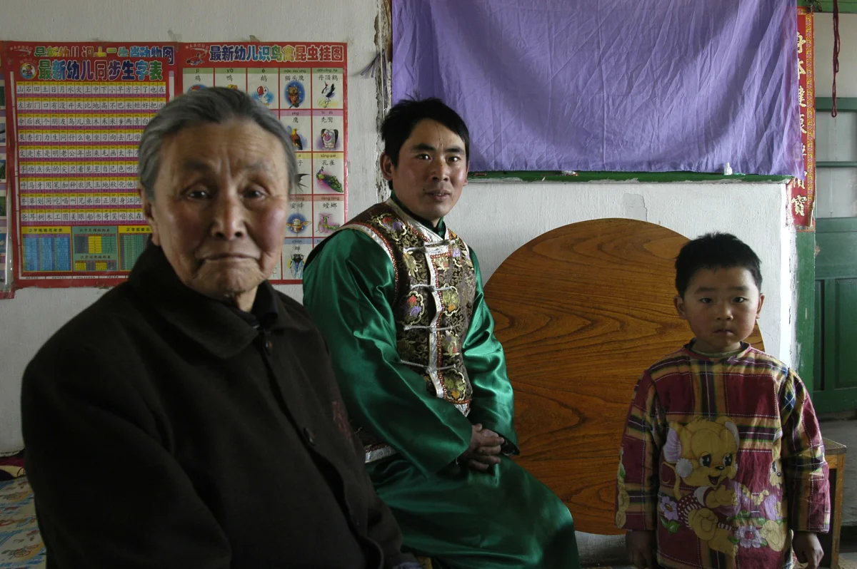 Meng Shujing (82) with grandson Shi Junguang (30) and great-grandson Shi Yaobin (5) at home in Sanjiazi near the town of Qiqihar in Heilongjiang province in North-east China. 2007