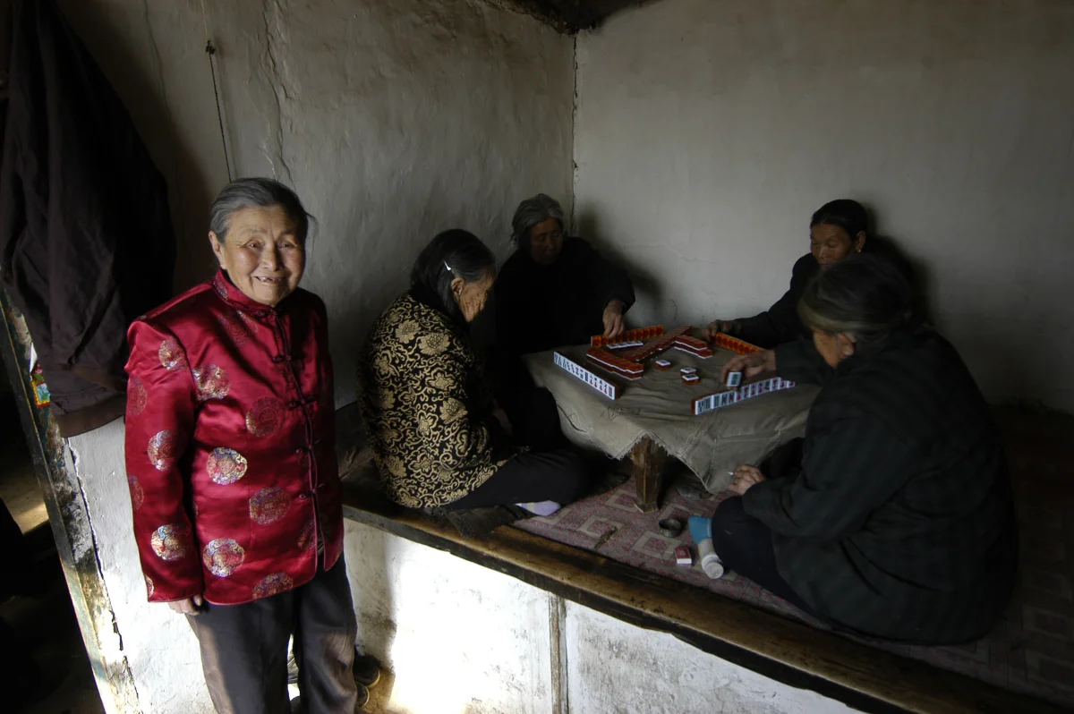 Meng Shujing (82)(L) with her two friends Yao Yun (82) (C) and Zhao Feng Lan (82) (R) also Manchu speakers in Sanjiazi near the town of Qiqihar in Heilongjiang province in North-east China. 2007